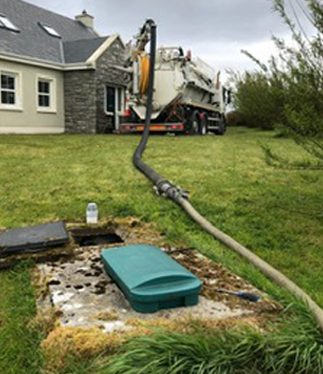 CES Operative carrying out a Septic Tank empty in a Domestic House