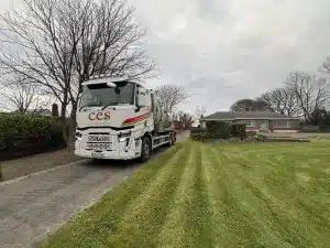 septic tank emptying to bungalow - CES truck carrying out septic tank emptying at a rural home
