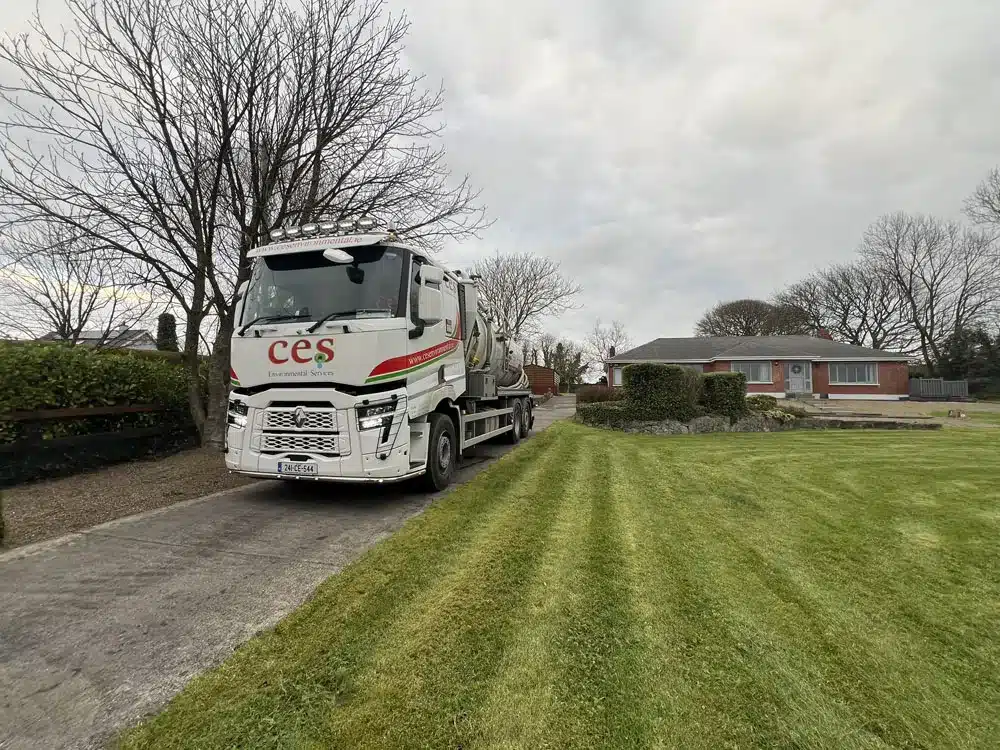 septic tank emptying to bungalow - CES truck carrying out septic tank emptying at a rural home